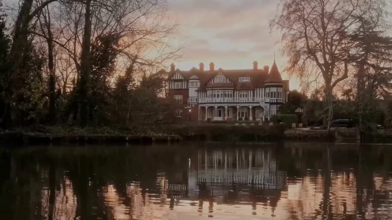 River Arts Club at dusk, the house lit against the evening sky above the Thames